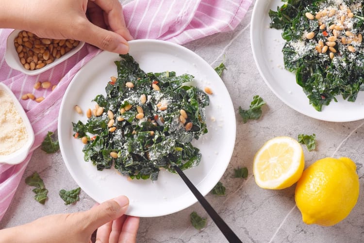 A lemon and kale salad with pine nuts