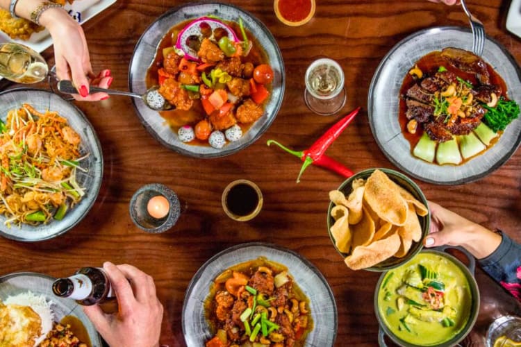 A selection of Thai dishes on a wooden table