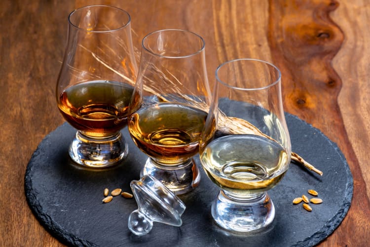 Three glasses of whiskey on a table