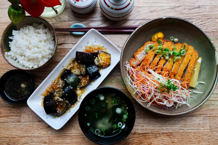 A flavourful Japanese lunch including katsu chicken, rice and miso soup.