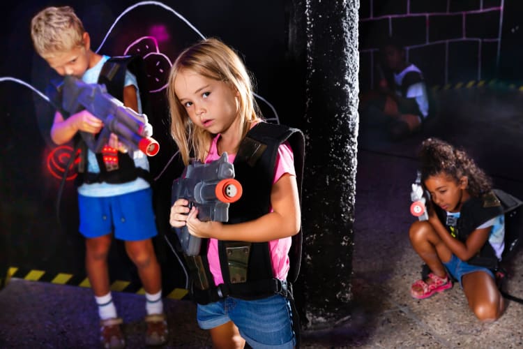 Three kids playing laser tag