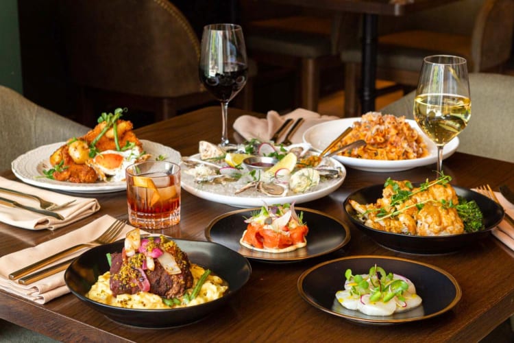 A selection of dishes and wine glasses on a dining table