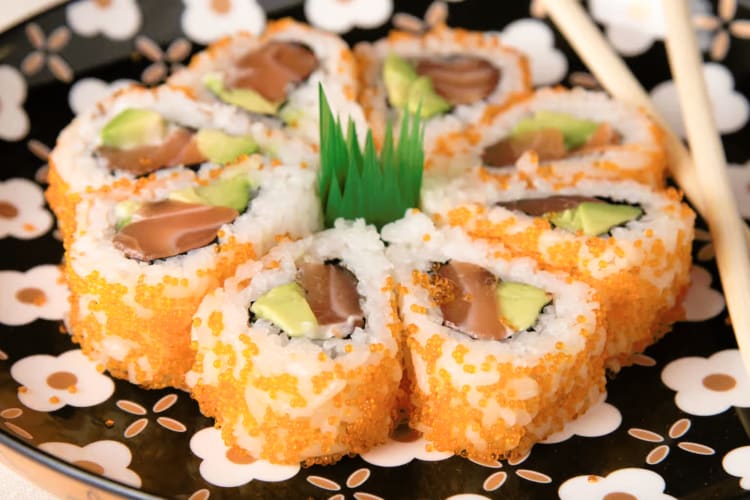 Sushi rolls with orange fish roe on the outside