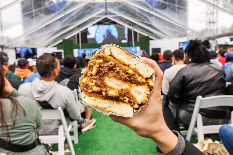 Person's hand holding a sandwich at Eeeeeatscon NYC