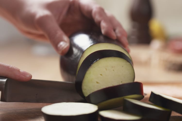 Slices of eggplant in rounds on a chopping board