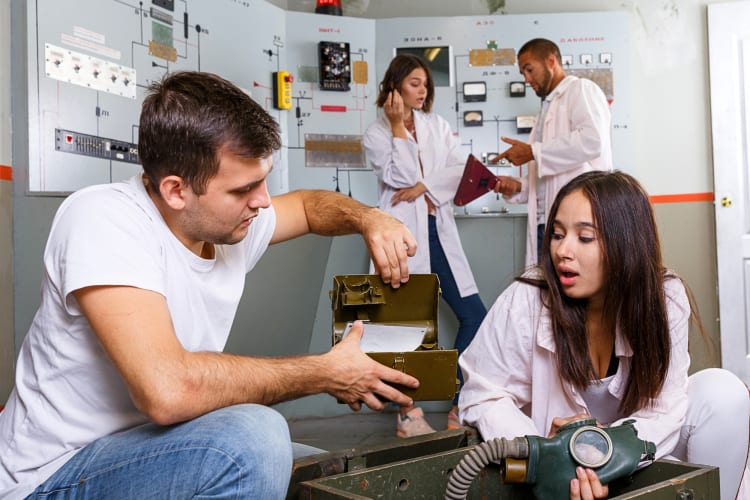 Four people figuring out how to get out of an escape room during a team building activity in Las Vegas