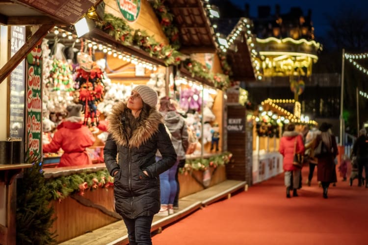 A person browsing stalls at a Christmas market