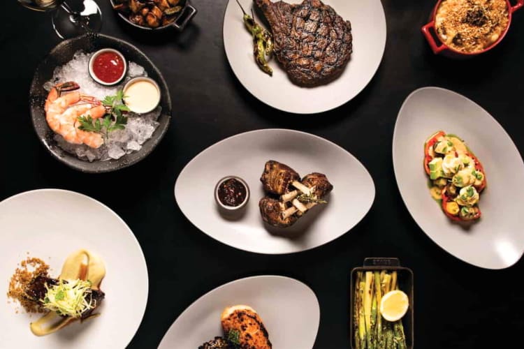 A selection of dishes on a black table