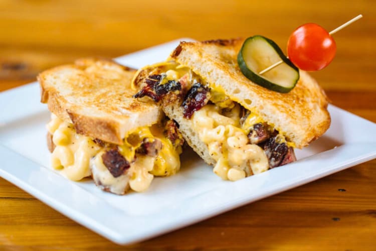 A macaroni and cheese grilled cheese sandwich on a plate