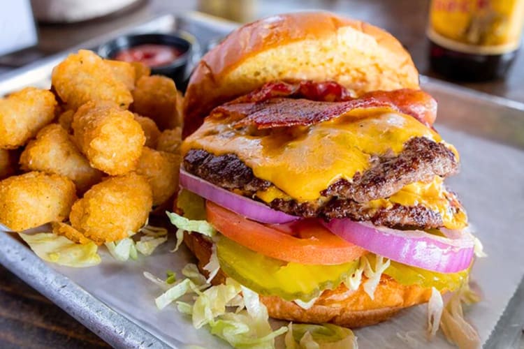 A burger and tater tots