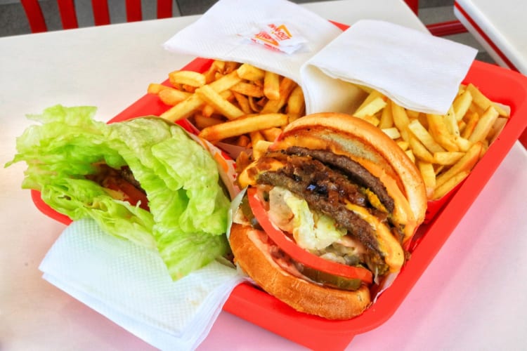 Burgers and fries on a red tray