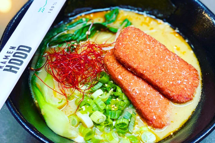 A bowl of ramen with chopsticks