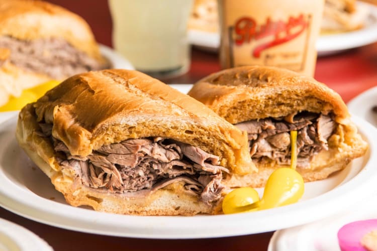 A French dip sandwhich on a white plate