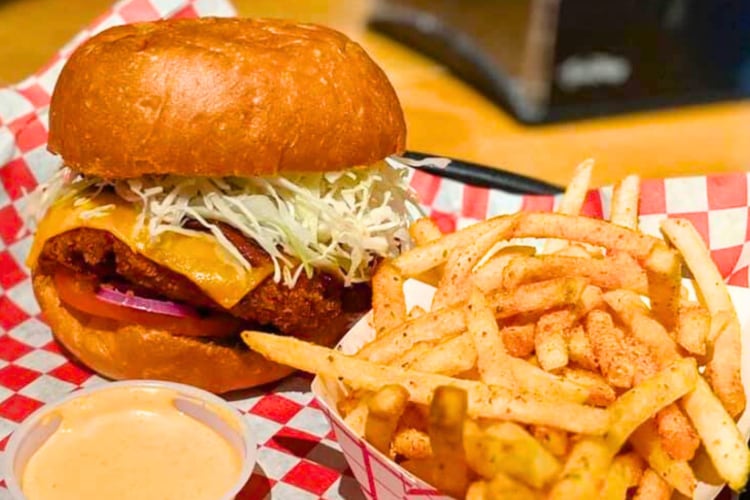 A burger and fries on red and white chequered paper