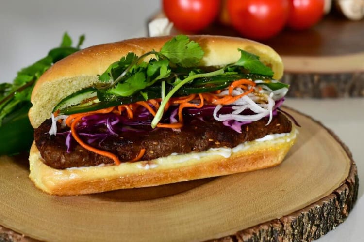 A banh mi sandwich on a wooden board