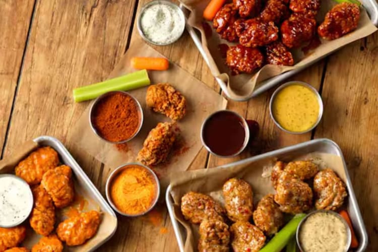 Fried chicken pieces and wings with a variety of spices and sauces fast food in Dubai