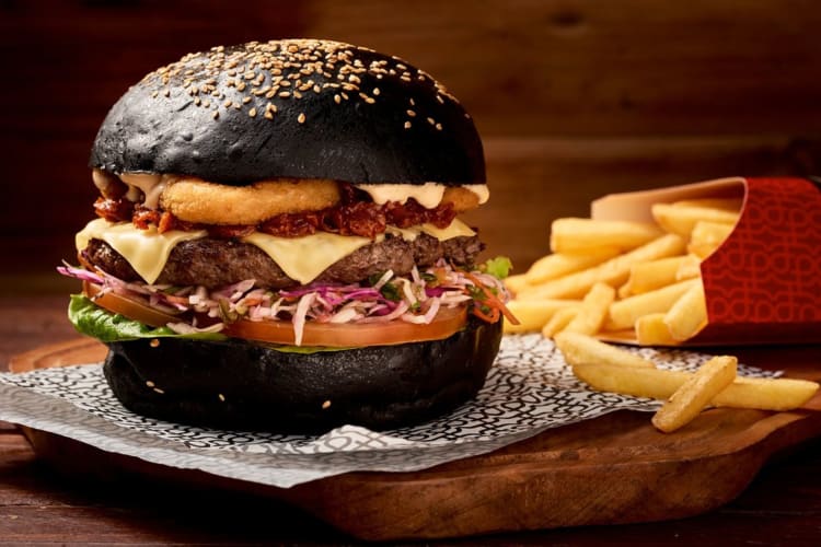 The Burger joint black bun fully loaded beef burger with fries
