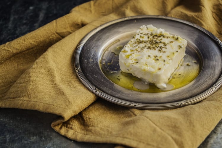 Feta cheese block with olive oil drizzled over