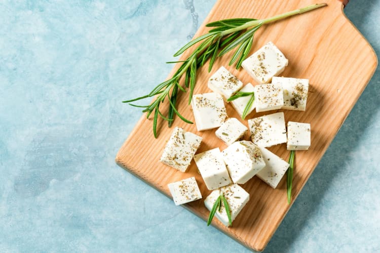 Feta cheese chopped on a wooden block