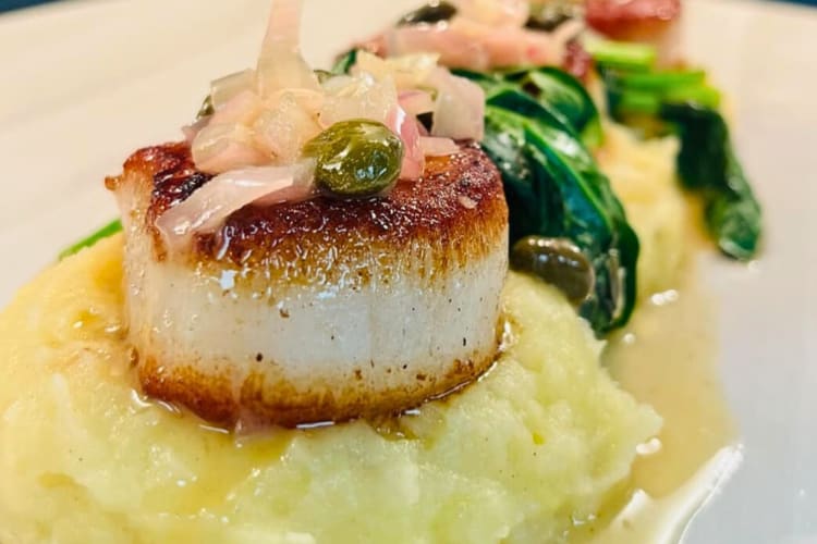 Close-up of a scallop on mashed potato from Fitzgerald