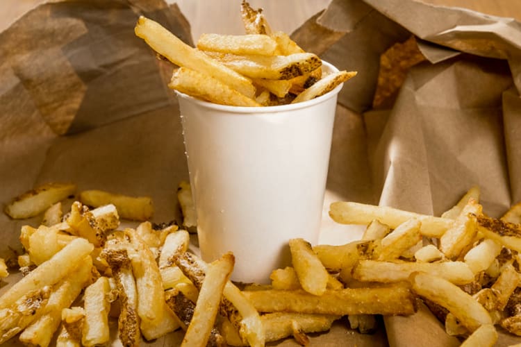 Five Guys fries on brown paper