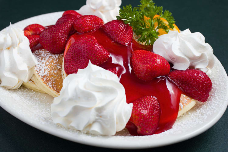 Pancakes covered in strawberries and cream, from Flappy Jack's Pancake House, a diner in Orange County