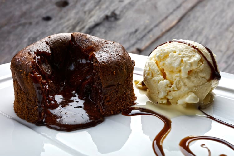 Chocolate lava cake and ice cream topped with chocolate sauce