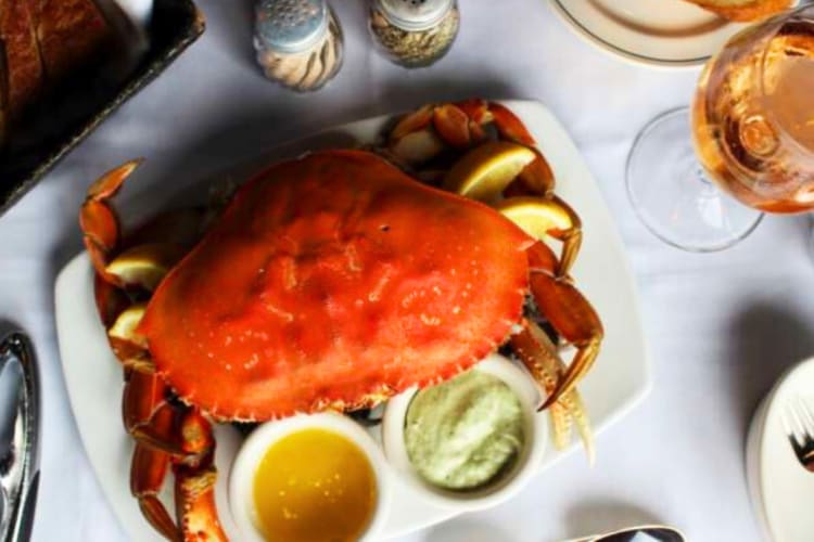A crab and two sauces from a restaurant in Seattle, one of the world's best foodie cities