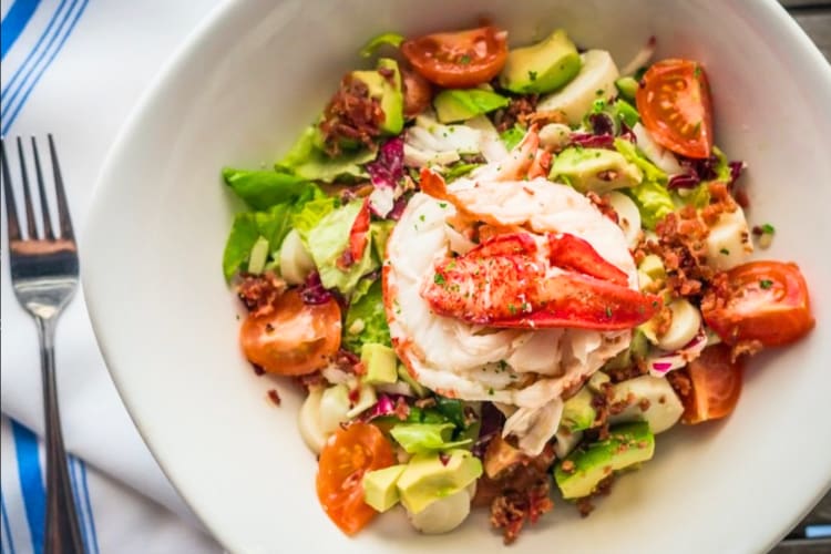 A lobster salad in a white ceramic bowl