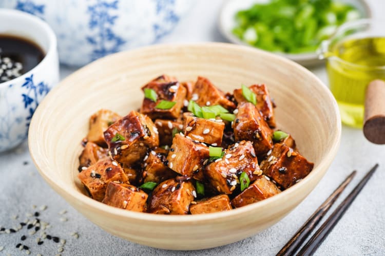 A tofu dish in a wooden bowl