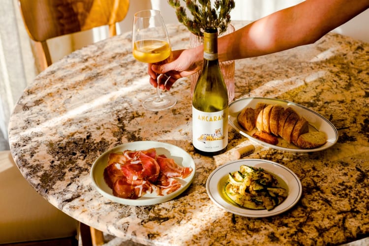 Antipasti and wine on a round marble table