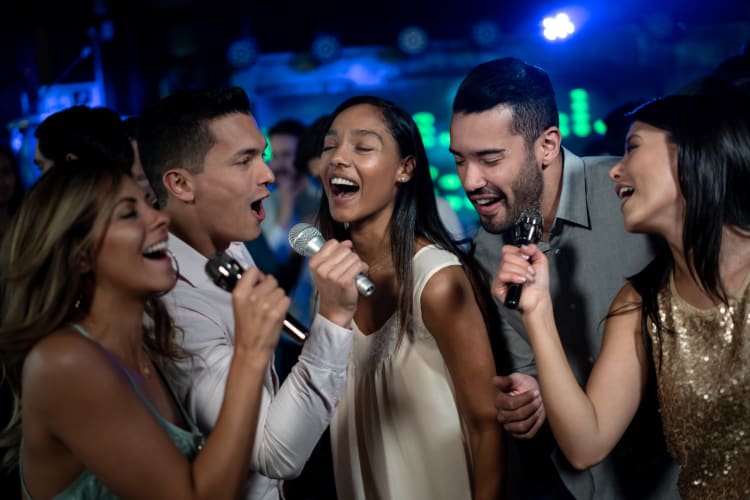 Friends singing karaoke together