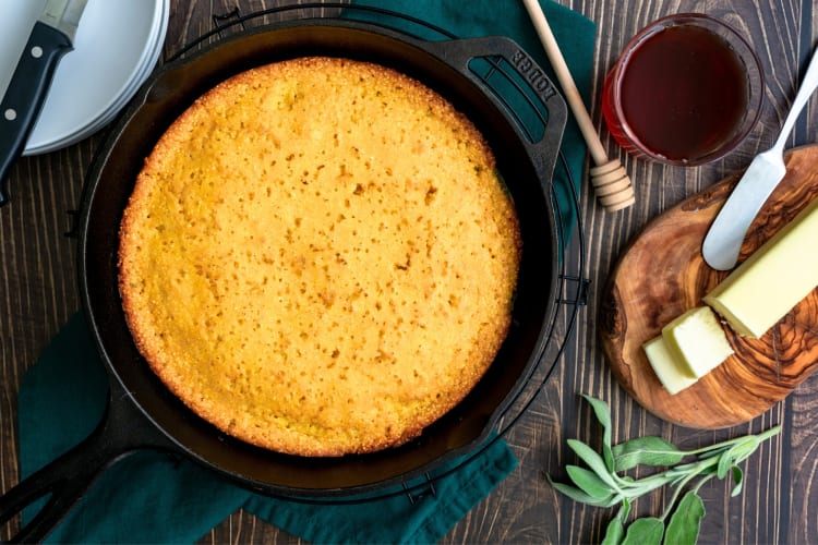 A cast iron pan with cornbread