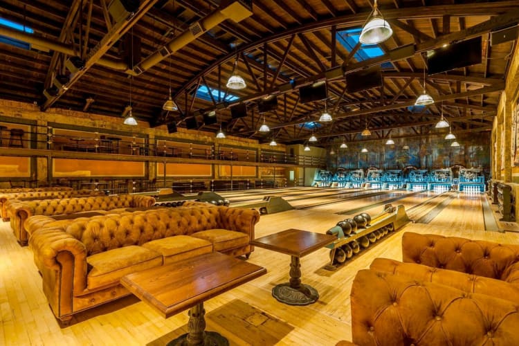 An upscale bowling alley with leather couches