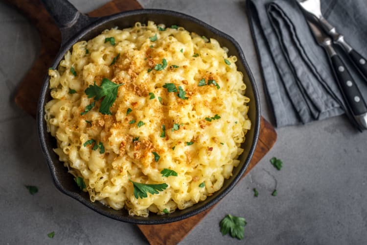 A cast iron pan with mac and cheese in it