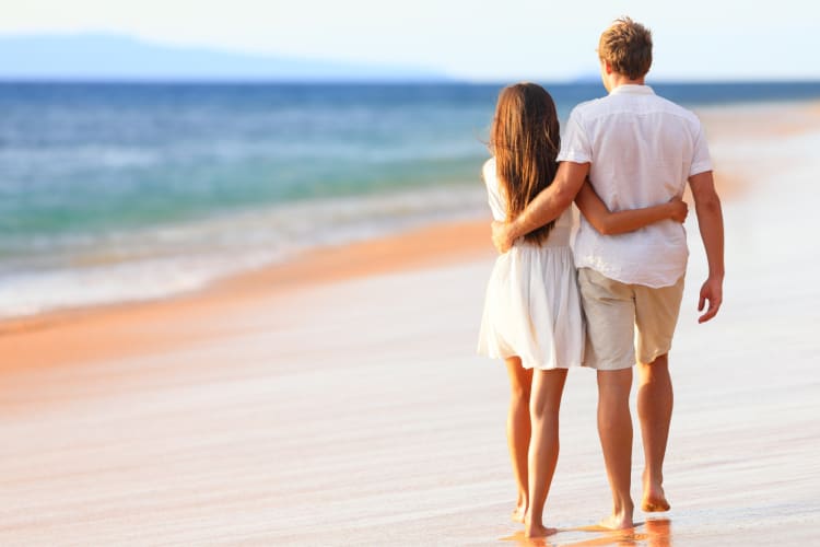 A couple walking on the beach