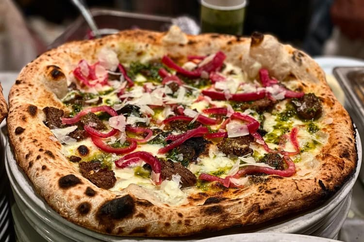 Pizza with skirt steak, house chimichurri and pickled red onions from Fuoco Pizzeria Napoletana