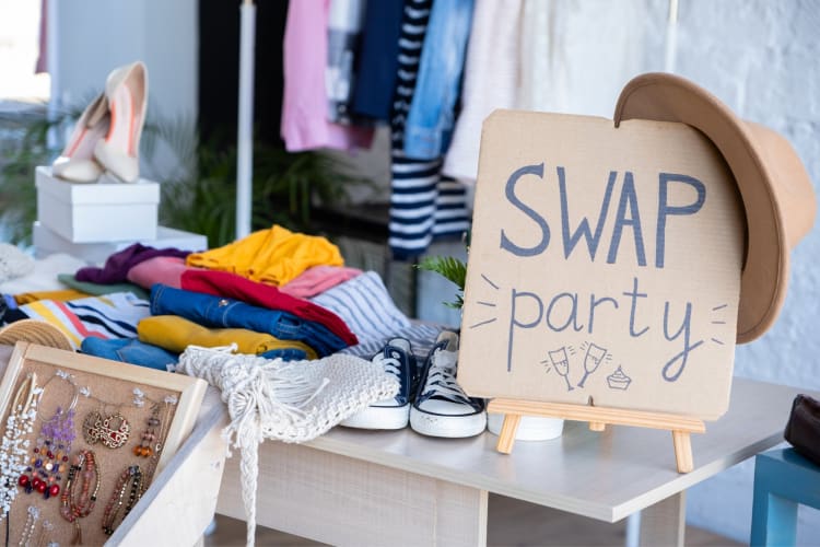 A swap party sign next to clothes and shoes
