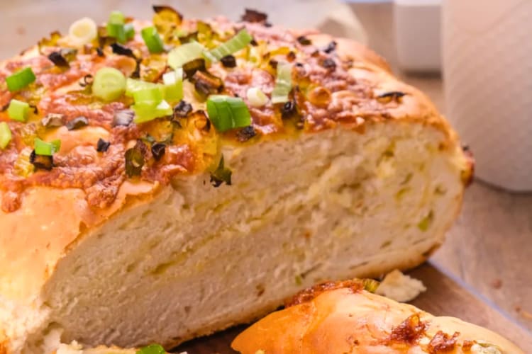 This jalapeno cheddar bread features sourdough bread with fresh jalapenos and crispy cheddar.