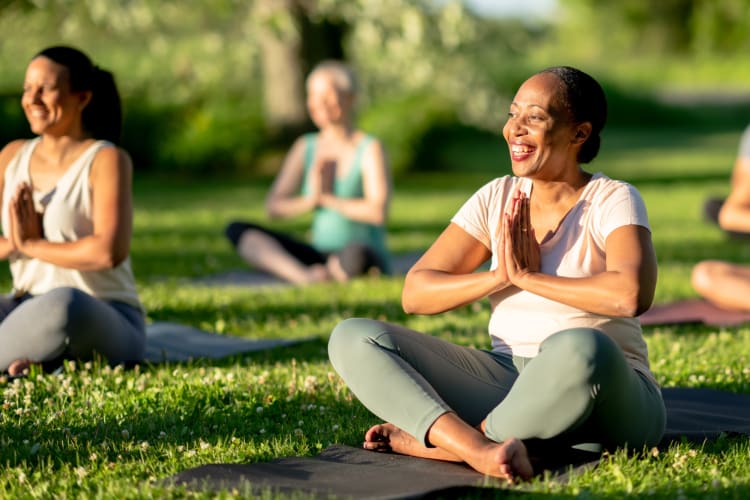 People doing yoga outside