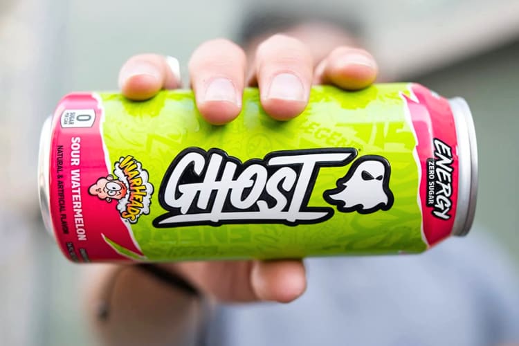 A person holding a Warhead Sour Watermelon Ghost Energy drink