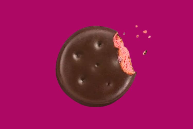 A Raspberry Rally Girl Scouts Cookie on a pink background