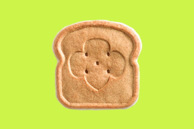 A toast-shaped cookie on a lime green background