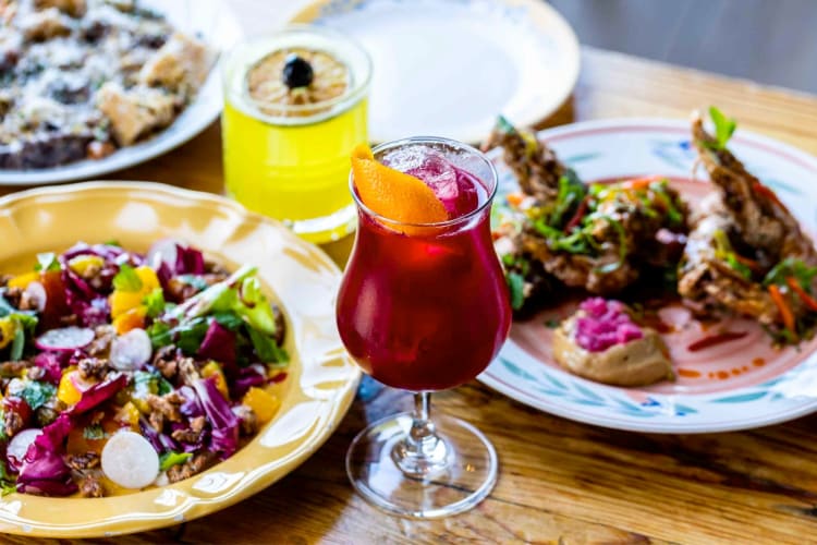 Dishes and colorful cocktails on a dining table