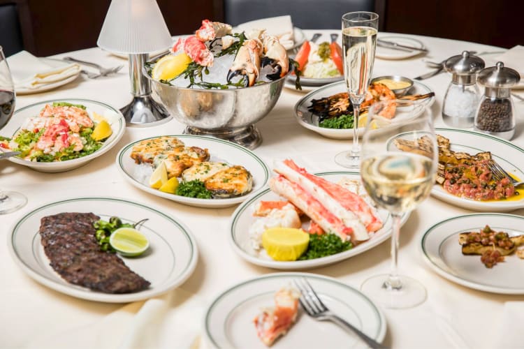 A selection of steak and seafood dishes on a table