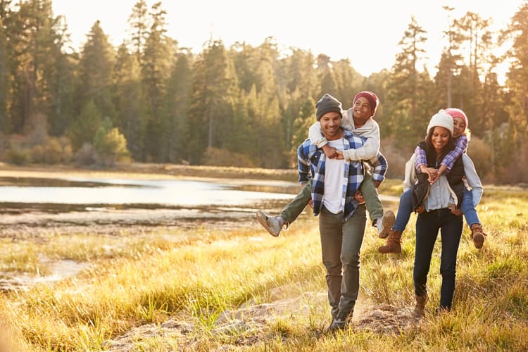 Father, mother and two children hiking together as a family Christmas tradition
