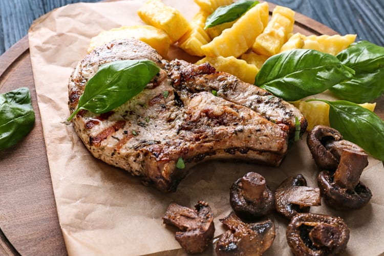 Steak frites meal with mushrooms on waxed paper