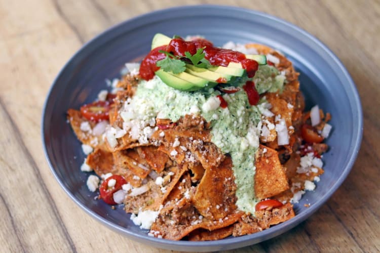 Nacho breakfast bowl with sliced avocado and sauce on top from the Orange County restaurant called Great Maple