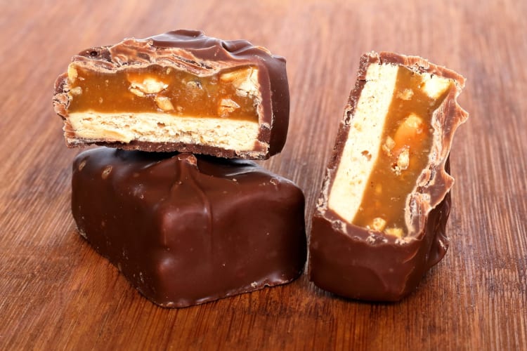 Candy bars with chocolate, caramel, peanuts and nougat