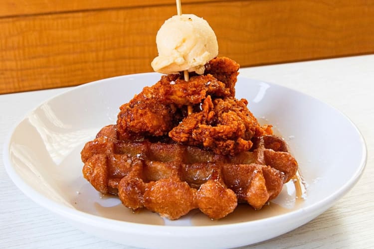 Chicken and waffle dish topped with ice cream, from Hancock